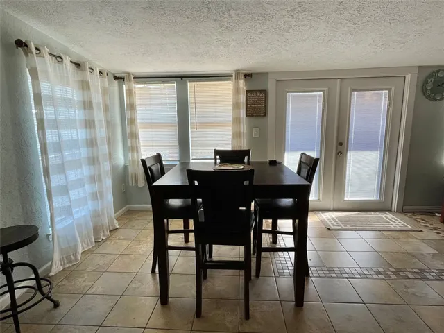 a view of a dining room with furniture and a window