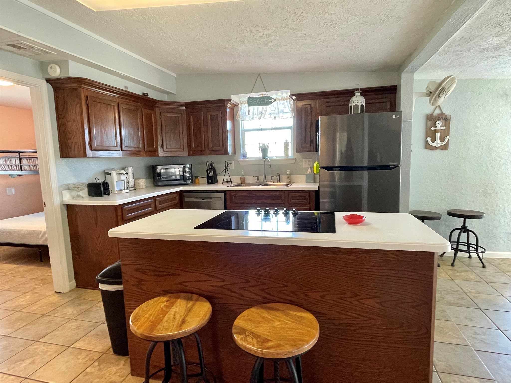 308 Parkview Road Surfside Beach, TX 77541 - Photo 7 of 18 a kitchen with stainless steel appliances granite countertop a sink a stove a refrigerator a washer and dryer