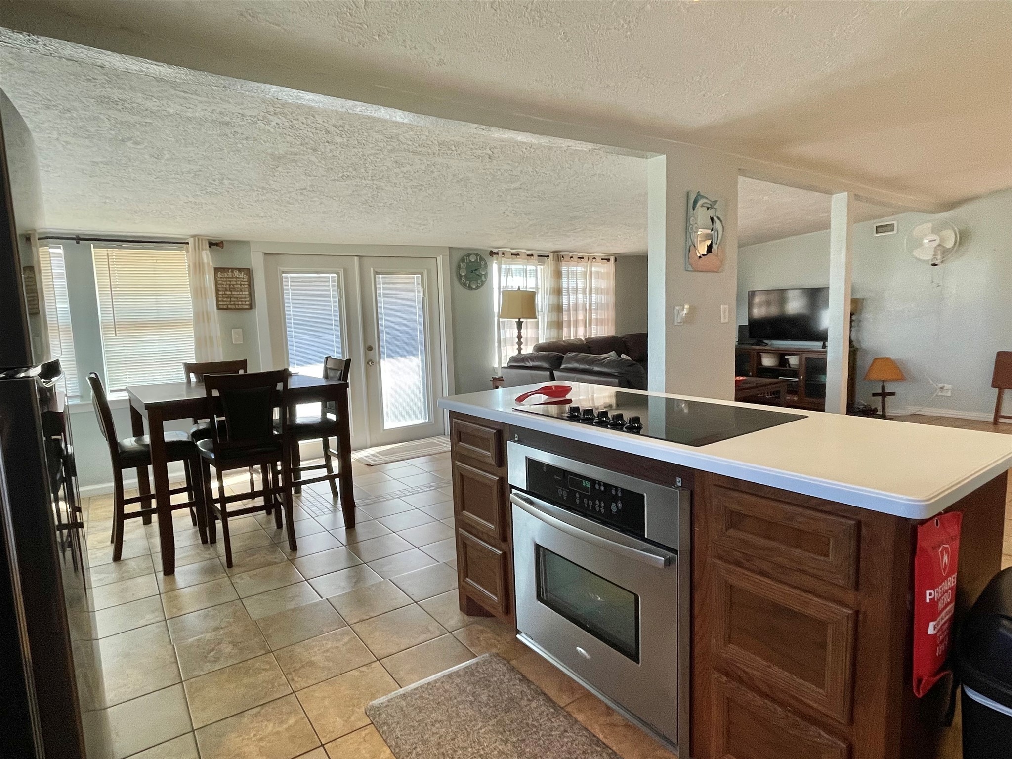 308 Parkview Road Surfside Beach, TX 77541 - Photo 9 of 18 a kitchen with a stove a sink dishwasher and a dining table with chairs