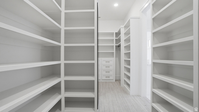 1682 North 1950 W Street, Unit 9 Provo, UT 84604 - Photo 35 of 84 Expansive walk-in closet featuring built-in shelving, integrated drawer storage, a hanging rod, recessed lighting, and light-toned flooring