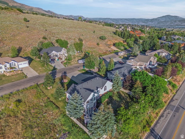 4117 North Wolf Ridge Circle Eden, UT 84310 - Photo 62 of 63 Suburban residence featuring a dark gray roof, light-colored siding, and a paved driveway
