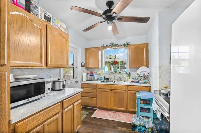 a kitchen with a sink cabinets and window