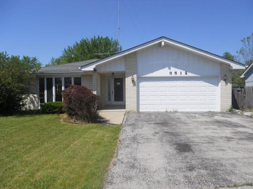 3512 Ronald Road Crete, IL 60417 - Photo 1 of 14 a front view of house with yard and trees in the background