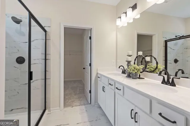 a bathroom with a double vanity sink shower and a mirror