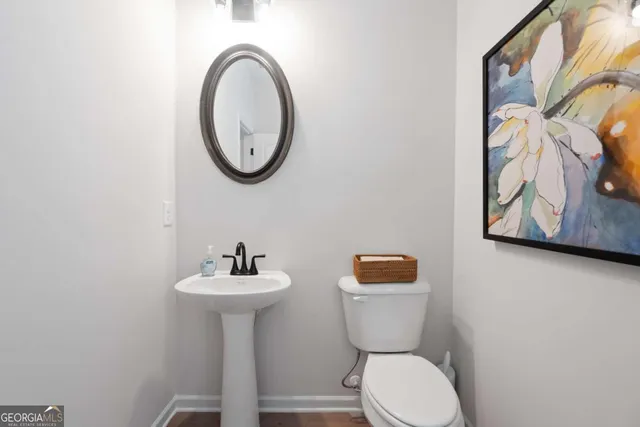 a bathroom with a toilet a sink and a mirror