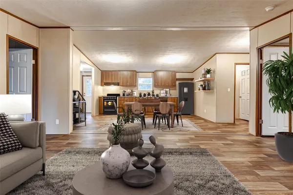 a living room with furniture and wooden floor