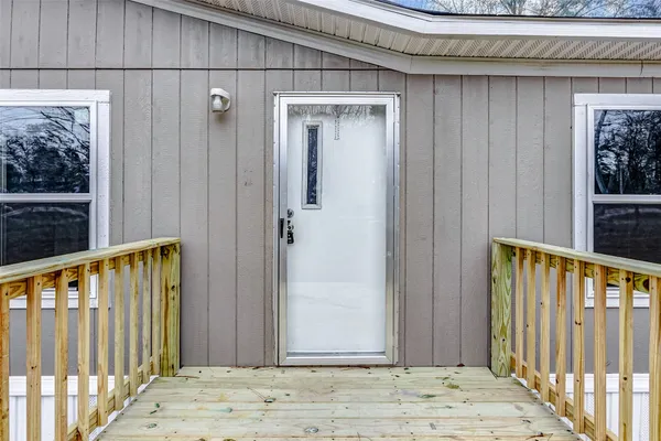 a view of a house with backyard and trees