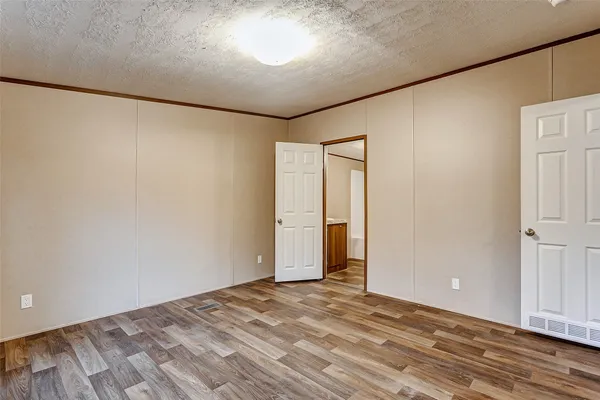 a living room with furniture and a dining table with wooden floor