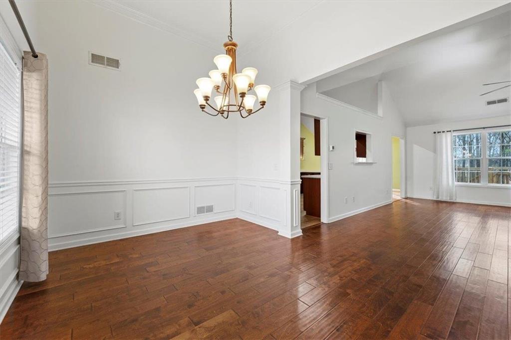 1218 Morgans Run Monroe, GA 30656 - Photo 32 of 39 an empty room with wooden floor and windows