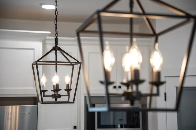 a kitchen with granite countertop white cabinets and stainless steel appliances