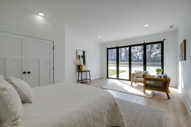 a bedroom with a bed and a lamp