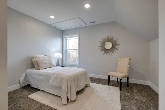 a bedroom with a bed and a chair