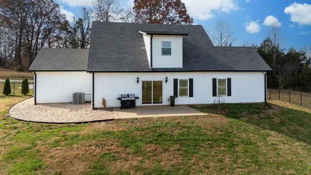 a view of swimming pool with outdoor seating and yard in back