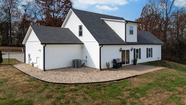 an aerial view of a house with a yard basket ball court and outdoor seating