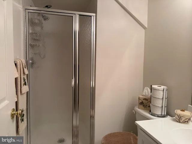 a bathroom with a sink toilet and mirror