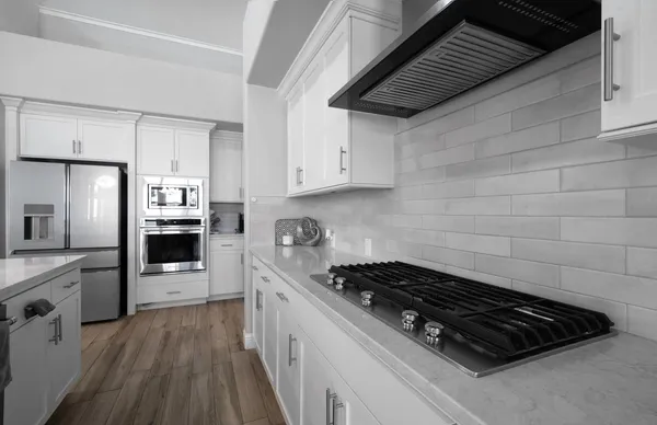 a kitchen with stainless steel appliances a refrigerator stove and microwave