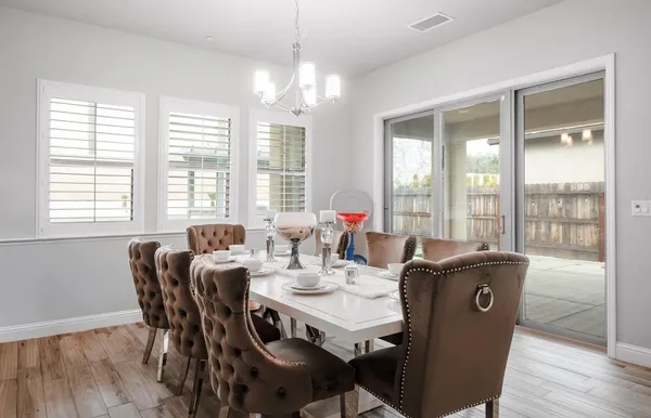 a living room with kitchen island furniture and a chandelier