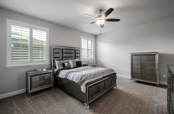 a spacious bedroom with a bed and a table in it