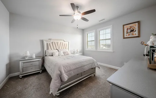 a bedroom with a large bed and a window