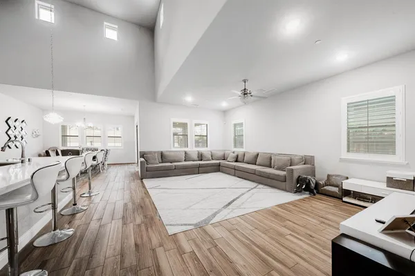 a living room with furniture and a wooden floor