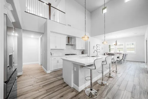 a kitchen with a sink cabinets and wooden floor