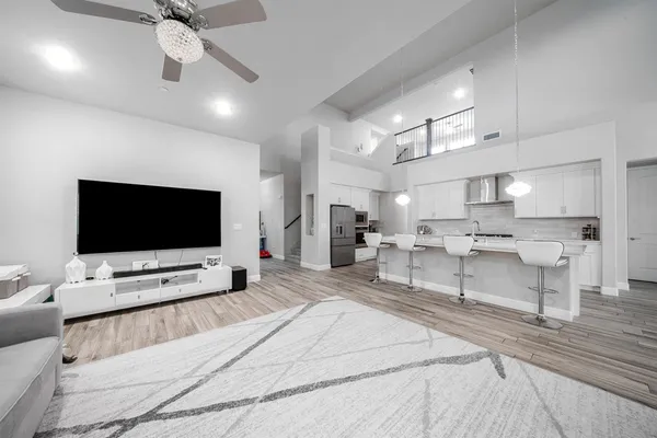 a large white kitchen with stainless steel appliances