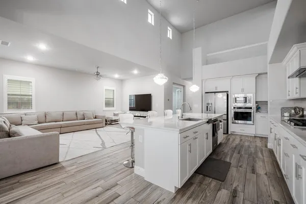 a kitchen with stainless steel appliances granite countertop a stove and a refrigerator
