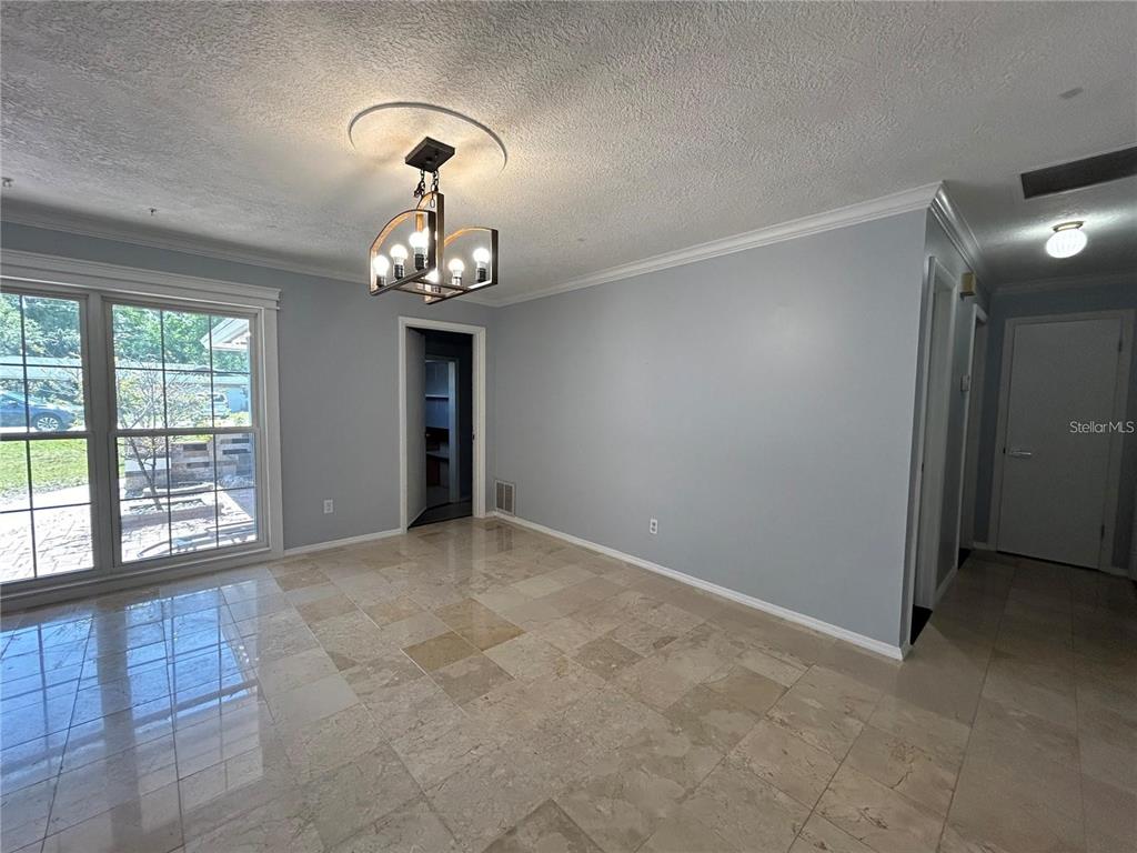 321 Ridgewood Street Altamonte Springs, FL 32701 - Photo 13 of 50 a view of a livingroom with a chandelier fan and windows