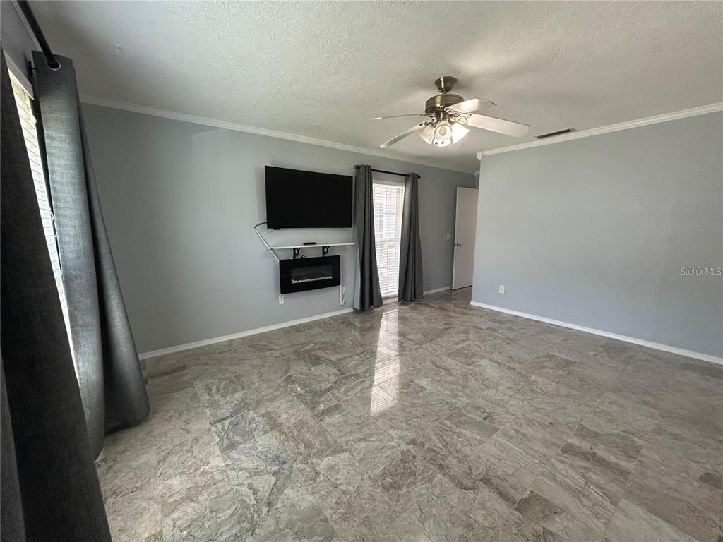 321 Ridgewood Street Altamonte Springs, FL 32701 - Photo 15 of 50 an empty room with windows and flat screen tv