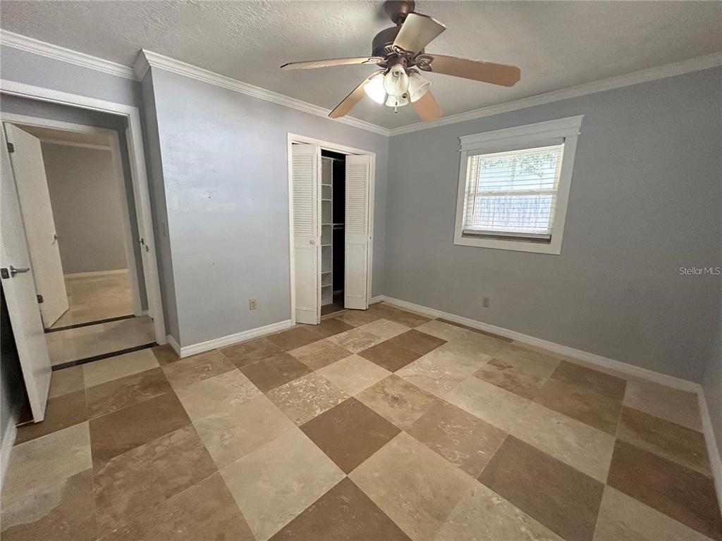 321 Ridgewood Street Altamonte Springs, FL 32701 - Photo 22 of 50 a view of a livingroom with a chandelier fan and windows