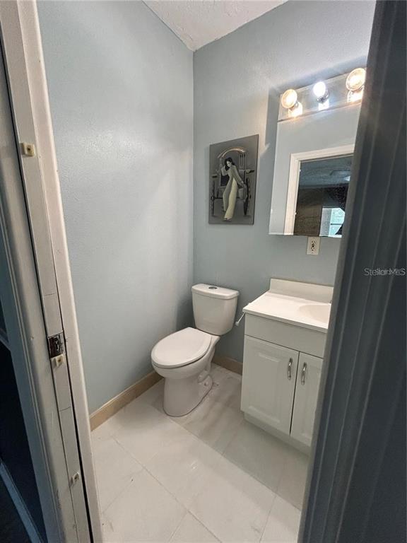 321 Ridgewood Street Altamonte Springs, FL 32701 - Photo 30 of 50 a white toilet sitting next to a bathroom sink