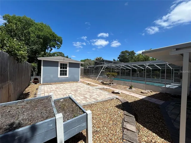 a view of a house with swimming pool and sitting area