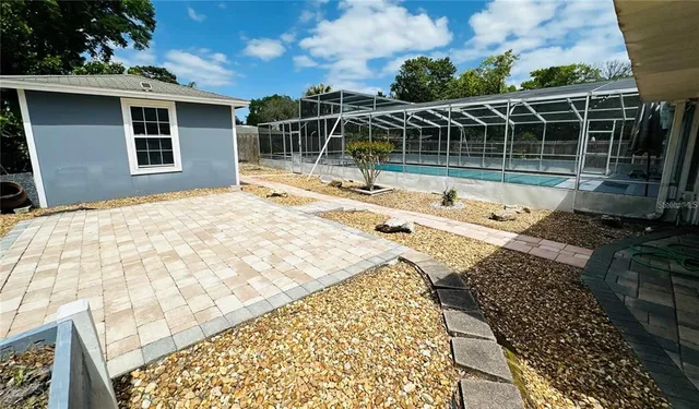 a view of a house with a backyard