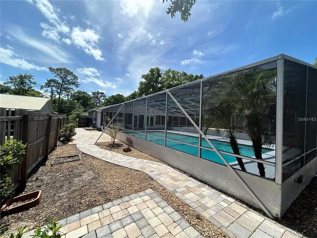 a view of a house with backyard and sitting area