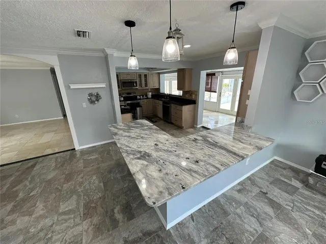 a view of a kitchen with refrigerator and windows