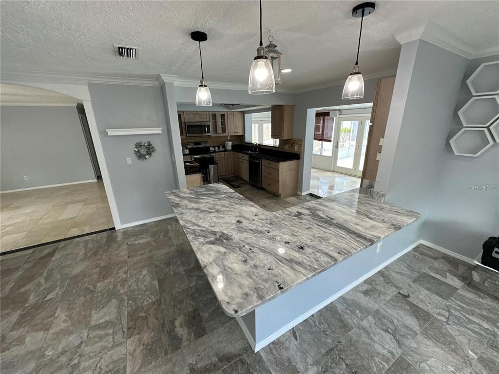 321 Ridgewood Street Altamonte Springs, FL 32701 - Photo 7 of 50 a view of a kitchen with refrigerator and windows