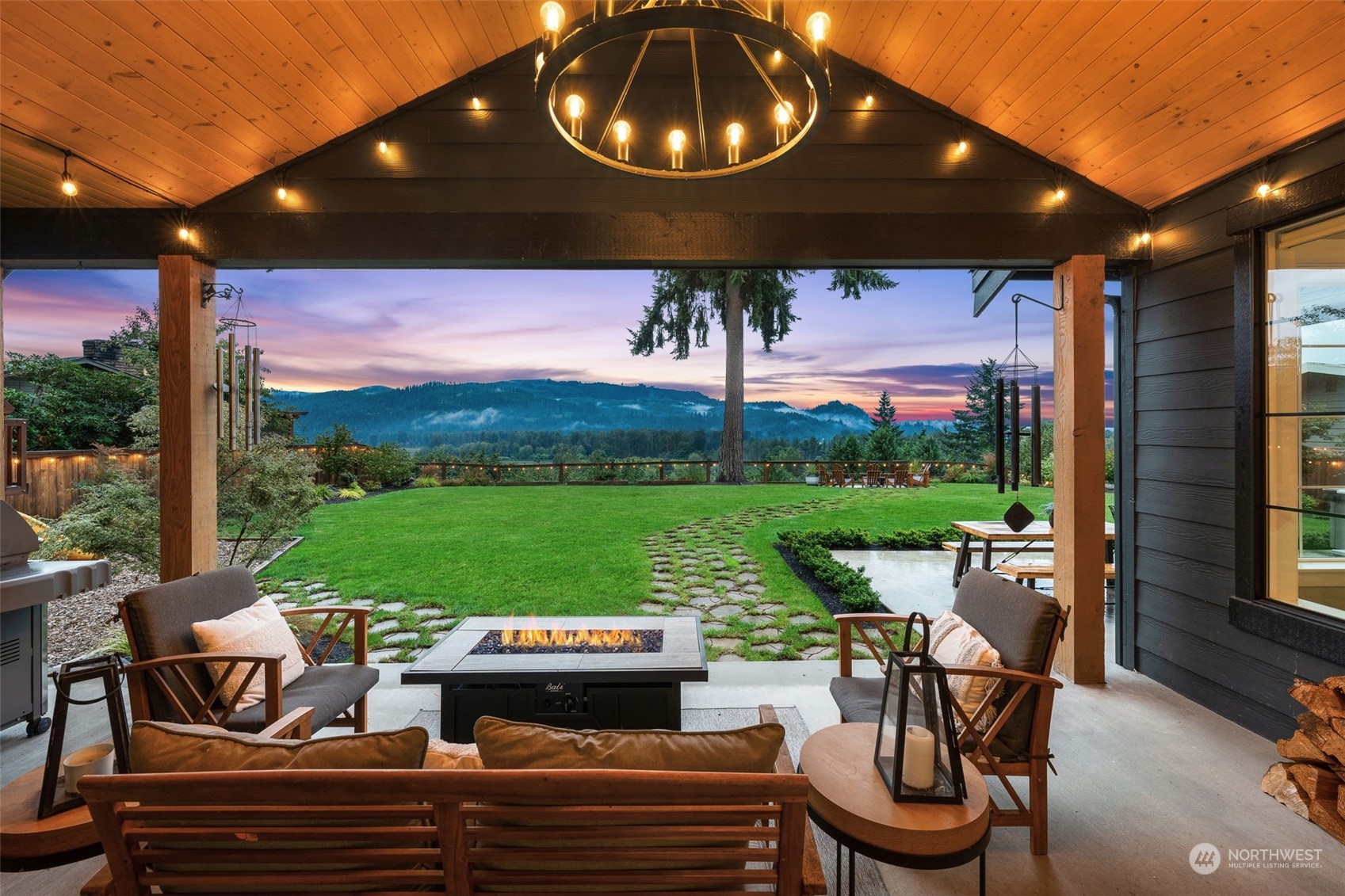 21468 Calhoun Road Monroe, WA 98272 - Photo 23 of 36 a view of a patio with table and chairs potted plants with wooden floor and lake view