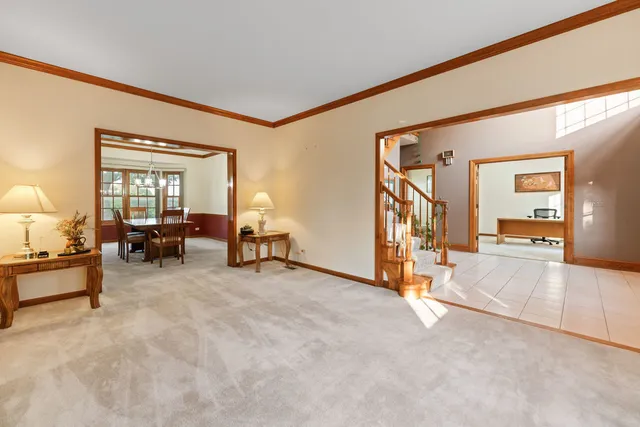 a kitchen with stainless steel appliances granite countertop a stove top oven a sink dishwasher a dining table and chairs with wooden floor