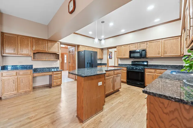 a view of a living room with furniture and wooden floor