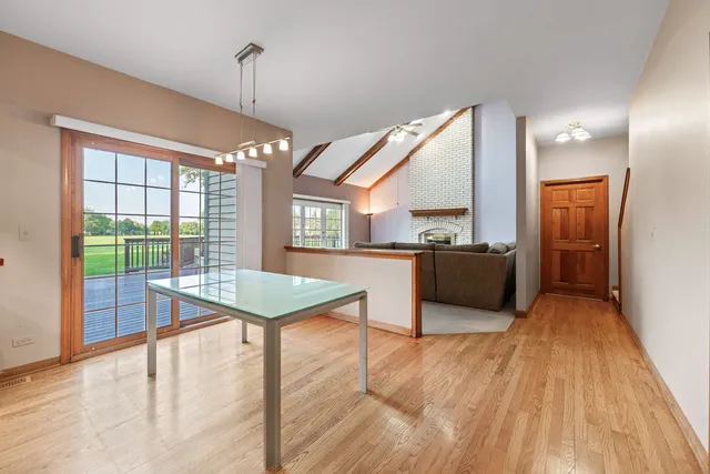 a view of a hallway with a door and stairs