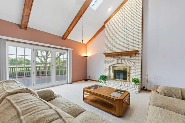 a spacious bathroom with a granite countertop double vanity and a mirror