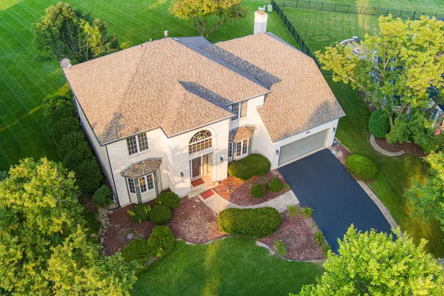 a aerial view of a house with swimming pool and garden