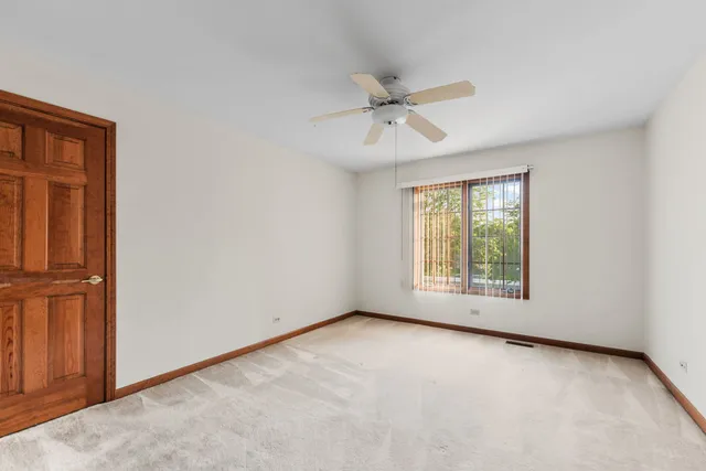 front view of house with a yard and potted plants