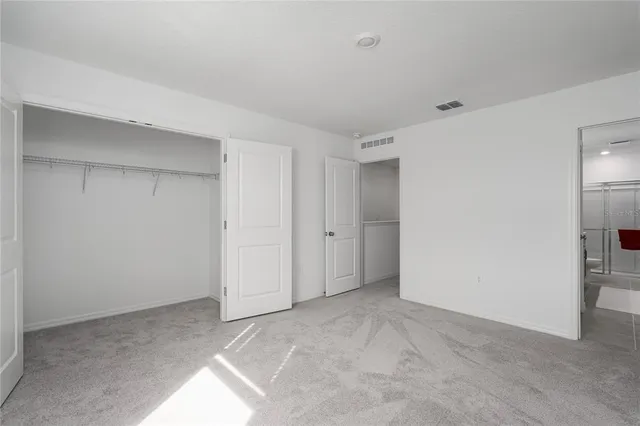 a bathroom with a sink a toilet a mirror and shower