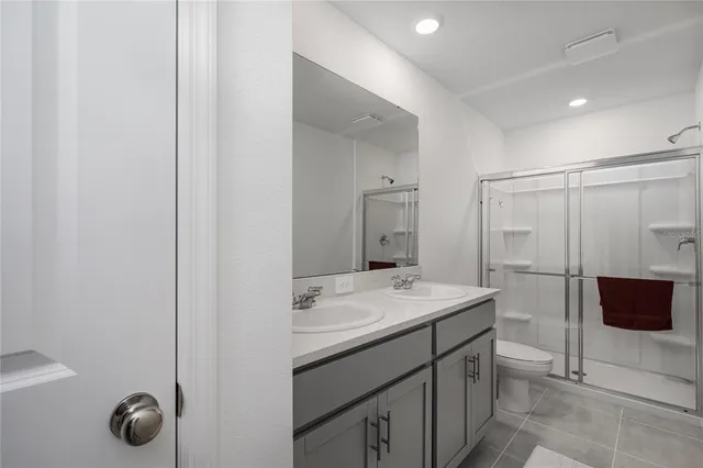 a front view of a house with a garden and trees