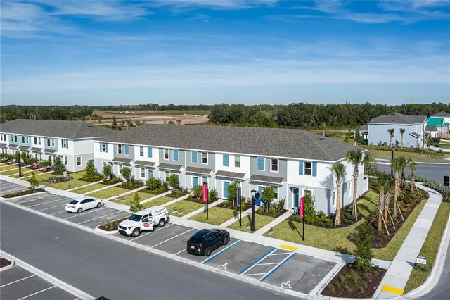 an aerial view of a house with a yard table and chairs