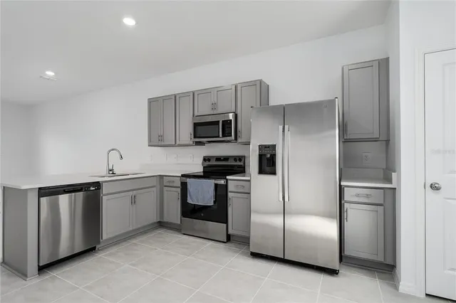 a kitchen with cabinets and stainless steel appliances
