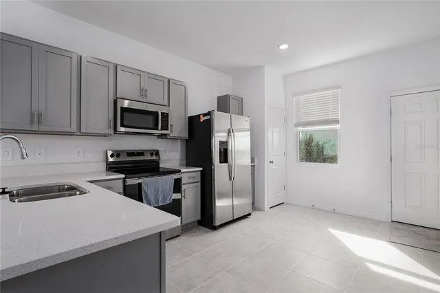 a kitchen with a refrigerator stove and microwave