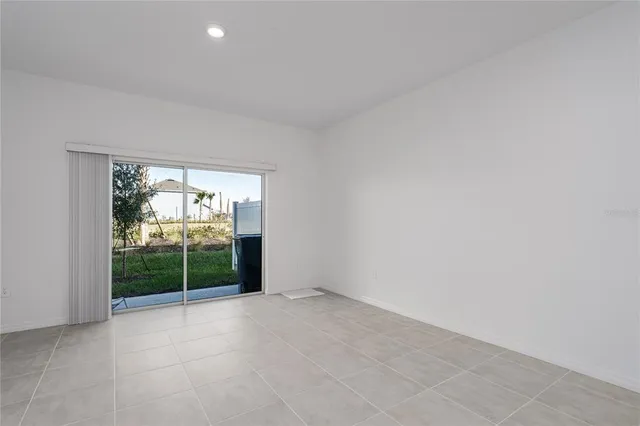 an empty room with large windows