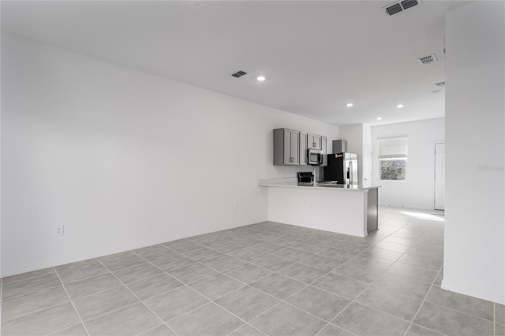 14052 Textile Run Parrish, FL 34219 - Photo 9 of 23 a view of kitchen with refrigerator and window